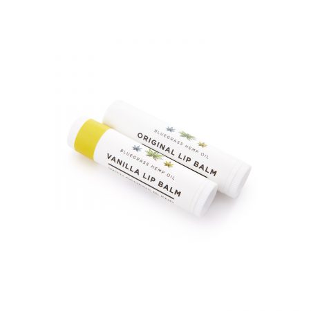 A close-up image of two CBD lip balms from Bluegrass Hemp Oil. One lip balm is original and the other is vanilla wafer.