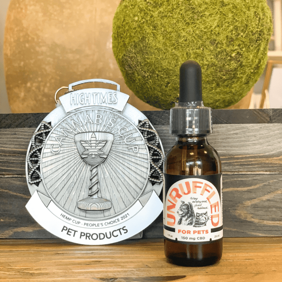 An image of the High Times Cannabis Hemp Cup award with Unruffled CBD oil for pets displayed next to it. Unruffled CBD oil is a winner of the silver cup.