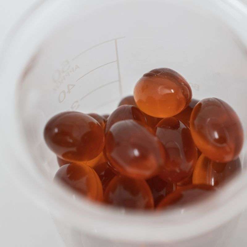 Image of a beaker half-filled with a blend of 10mg full spectrum CBD and Omega 3 from wild-caught salmon oil.