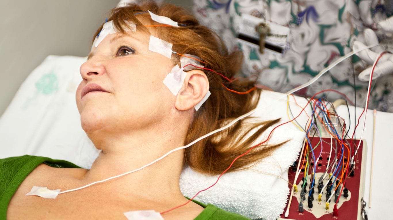 Woman undergoing EEG test to diagnose status epilepticus.
