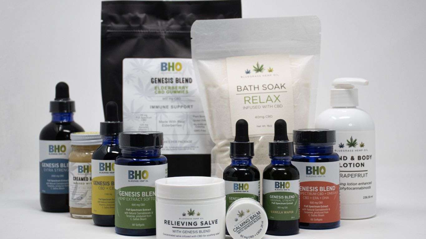 A variety of CBD products including oils, gummies, and topical creams displayed on a table, representing the wholesale range available at Bluegrass Hemp Oil and Kentucky Cannabis Company.